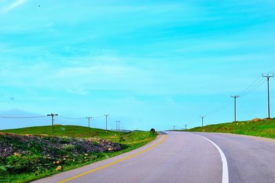 Country road against sky