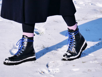 Low section of person on snowy field
