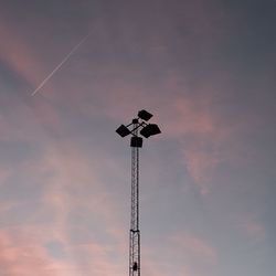 Low angle view of floodlight against sky during sunset