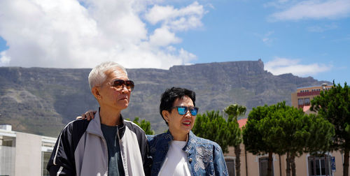Man and woman wearing sunglasses against sky