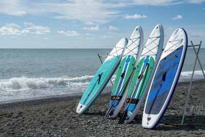 Surfboards on the seashore against the blue sky