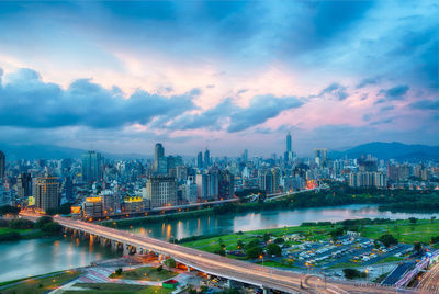 High angle view of cityscape against cloudy sky