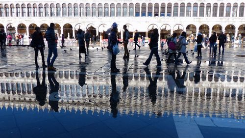 Group of people walking on wet floor