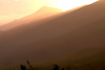 Scenic view of silhouette mountains against sky during sunset