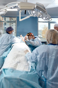Rear view of woman sitting in hospital