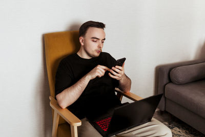 Young male programmer freelancer working from home