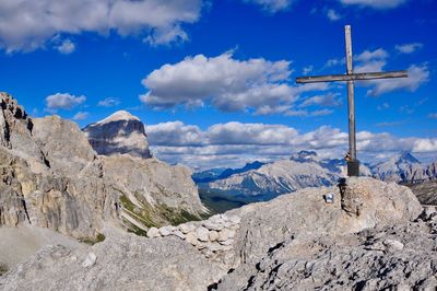 Panoramic view of cross on mountain against sky