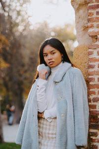 Portrait of young woman standing outdoors