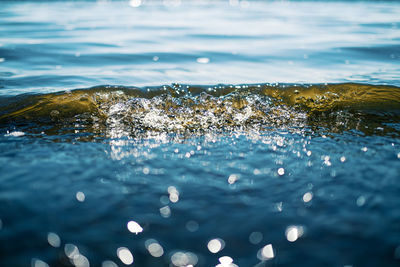 Close-up of sea wave splashing on rock