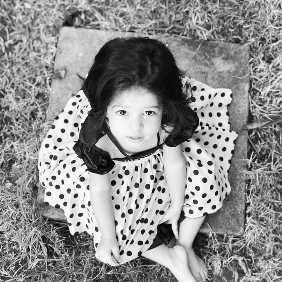 childhood, child, looking at camera, portrait, girls, one person, females, women, high angle view, full length, grass, real people, cute, leisure activity, field, innocence, sitting, lifestyles, polka dot, hairstyle