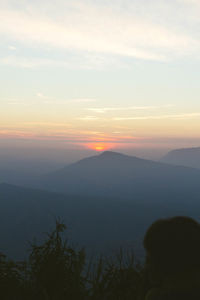 Scenic view of silhouette mountains against sky at sunset