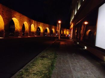 Illuminated tunnel at night