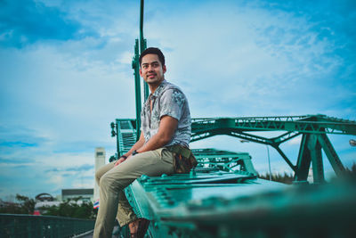 Low angle view of man standing against sky