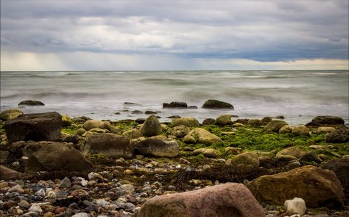 Scenic view of sea against cloudy sky