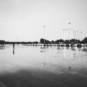 Scenic view of wet city against clear sky