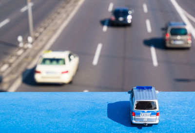 Close-up of car on road