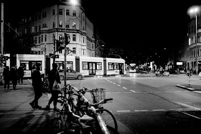 View of bicycles parked in city at night