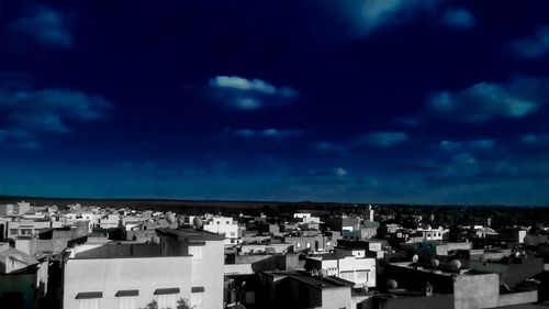 View of cityscape against blue sky