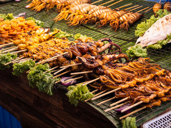 Fresh thai street food. seafood dishes with octopus and squids on skewers in bangkok, thailand.