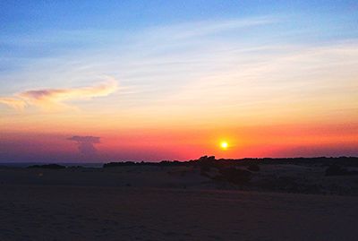 Scenic view of beach against sky during sunset