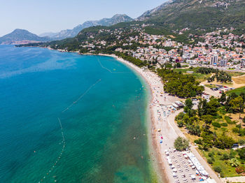 High angle view of sea and mountains against sky