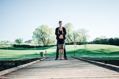 Portrait of young man standing against sky