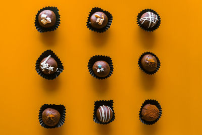 Full frame shot of multi colored candies against yellow background