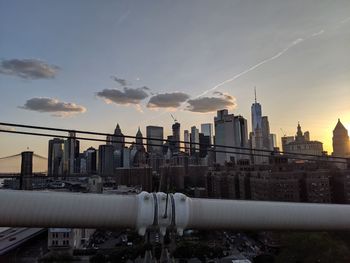 Buildings in city against sky during sunset