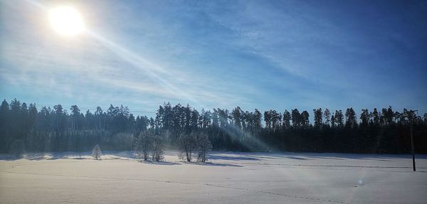 Scenic view of snow covered landscape against sky