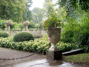 Statue by trees against plants