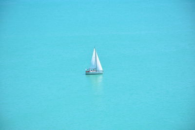 Sailboat sailing on sea against sky