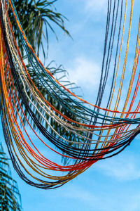 Low angle view of palm trees against blue sky