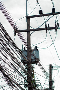 Thailand messy wires. including electrics, phone and others communication wires on pole in the city.