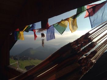 Low angle view of clothes drying against sky