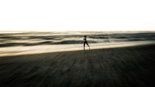 Man walking on land against sky