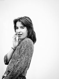 Portrait of beautiful young woman against white background