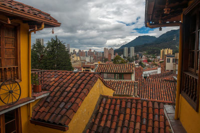 Residential buildings against cloudy sky