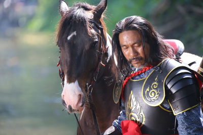 Man in warrior costume with horse