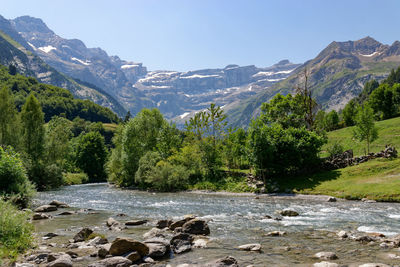 Scenic view of mountains and river against sky