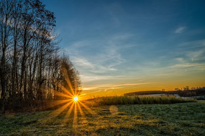 Scenic view of field against sky during sunset