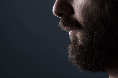 Close-up of man against black background