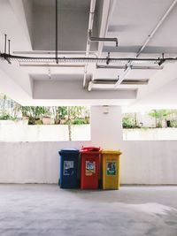 Telephone booth on floor against wall