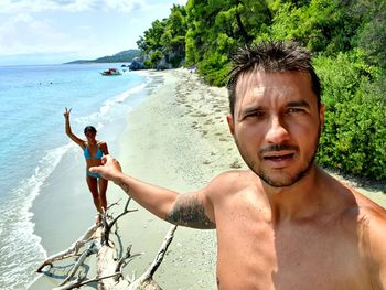 Portrait of shirtless young man at beach