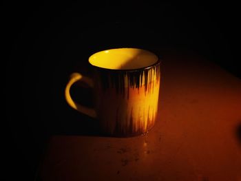 Close-up of illuminated coffee cup on table