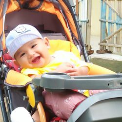 Portrait of smiling boy in baby stroller