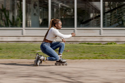 Side view of woman sitting on road