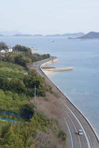 High angle view of road by sea against sky