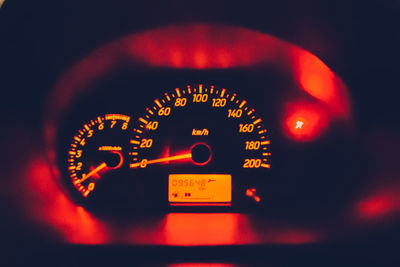 Close-up of illuminated red speedometer in car