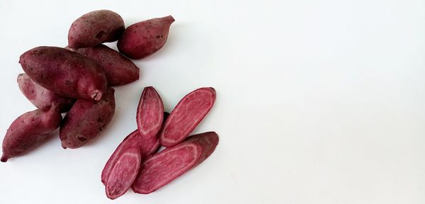 High angle view of red chili over white background