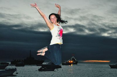 Young woman with umbrella in background